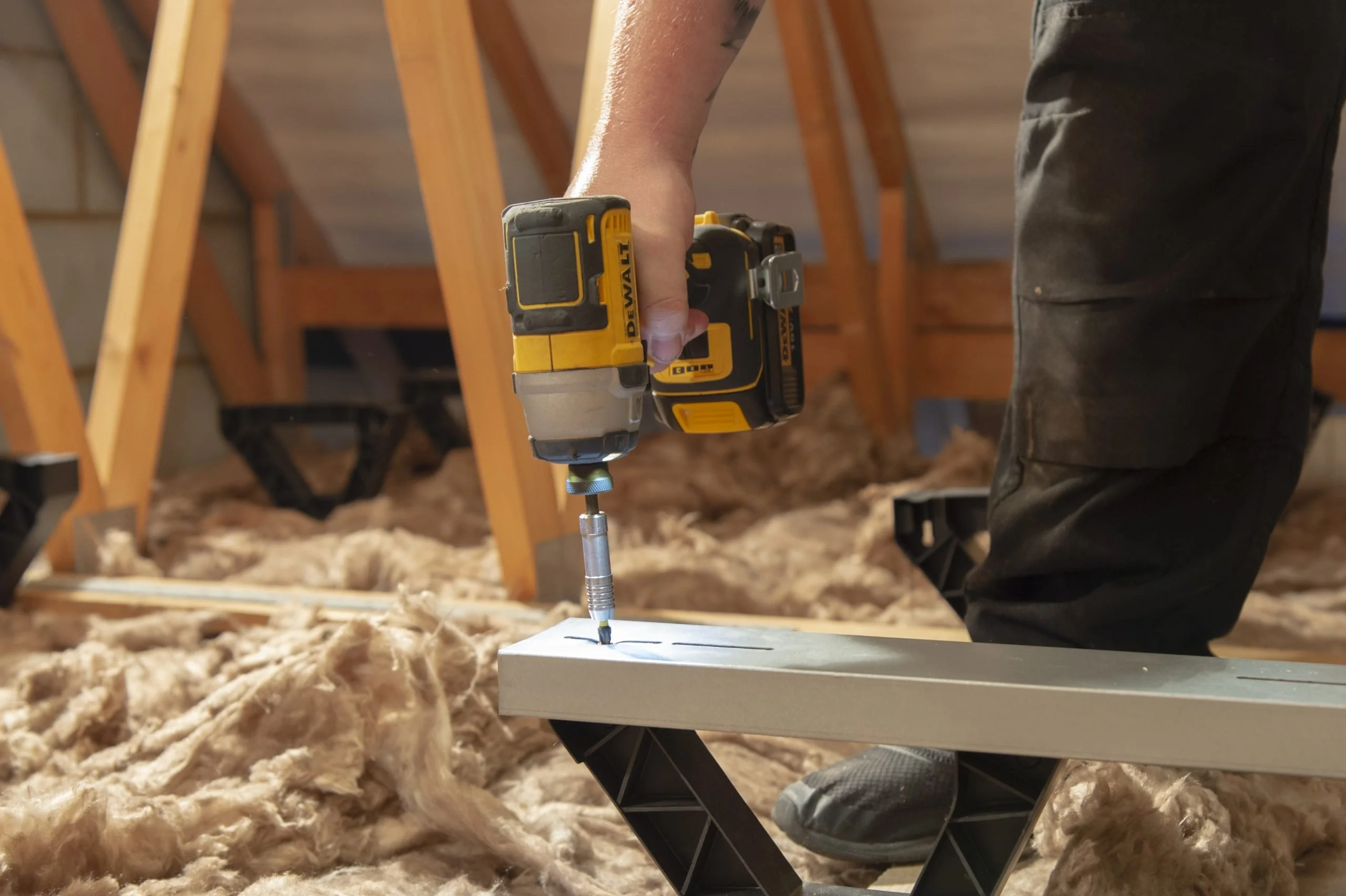 screwdriver being used to screw in loft board mounts